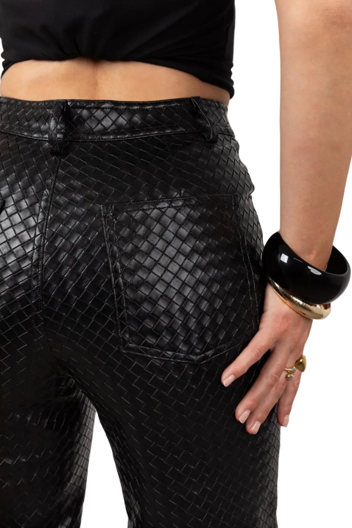 Black textured pants worn by a person on a white background
