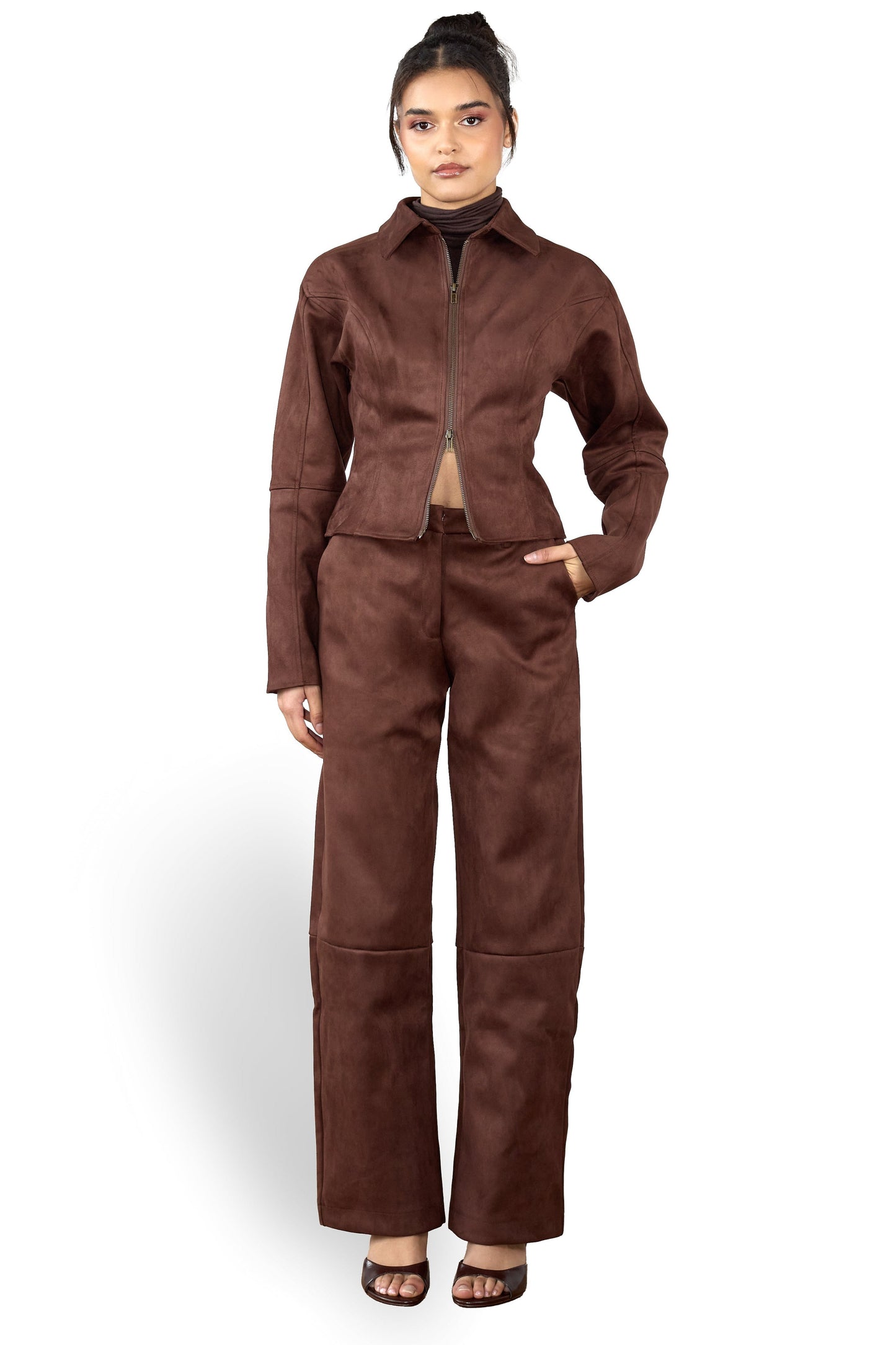 Woman wearing a brown suede suit on a white background