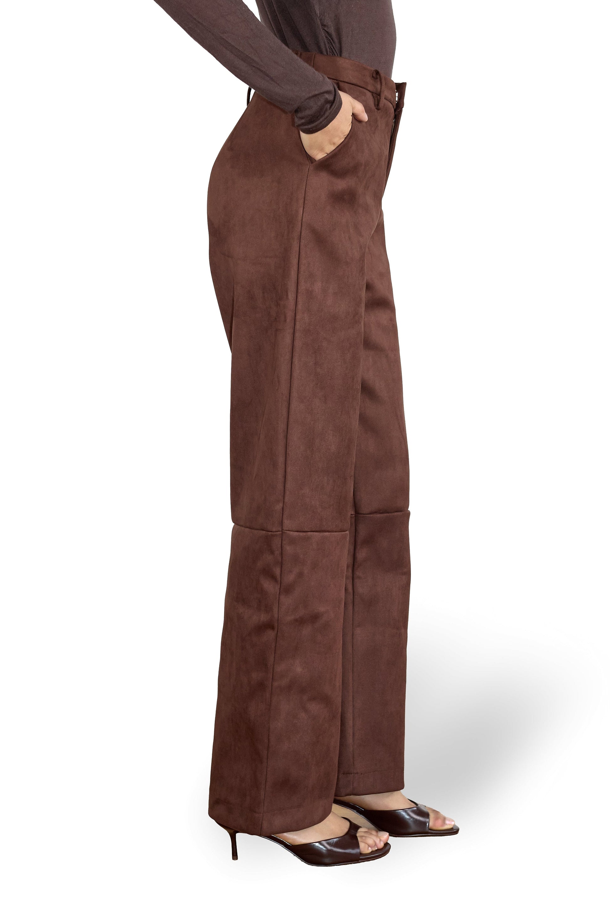 Brown suede pants worn by a person on a white background