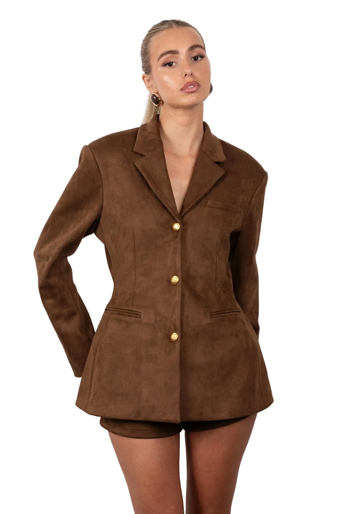 Woman wearing a brown suede jacket and shorts on a white background