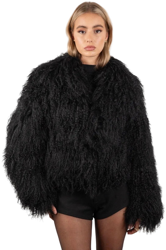 Person wearing a Black Mongolian fur coat on a white background