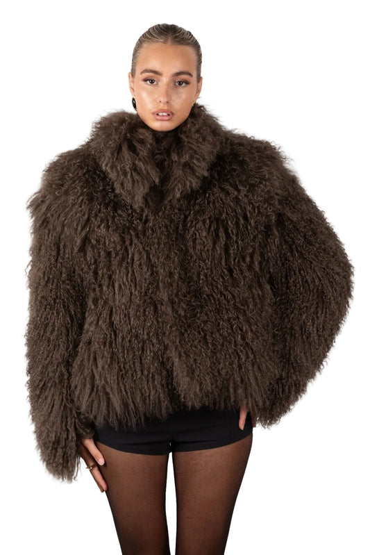 Person wearing a brown Mongolian fur coat on a white background