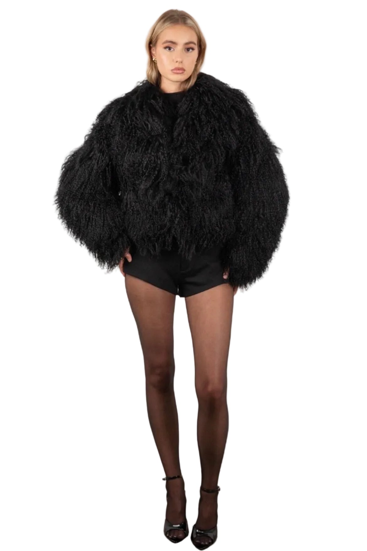 Person wearing a Black Mongolian fur coat over a black outfit on a plain background