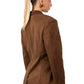 Woman wearing a brown blazer with gold buttons on a white background
