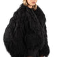 Person wearing a Black Mongolian fur coat on a white background