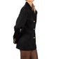 Woman wearing a Black suede blazer with gold buttons on a white background