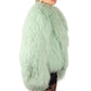 Person wearing a light green Mongolian fur  coat on a white background