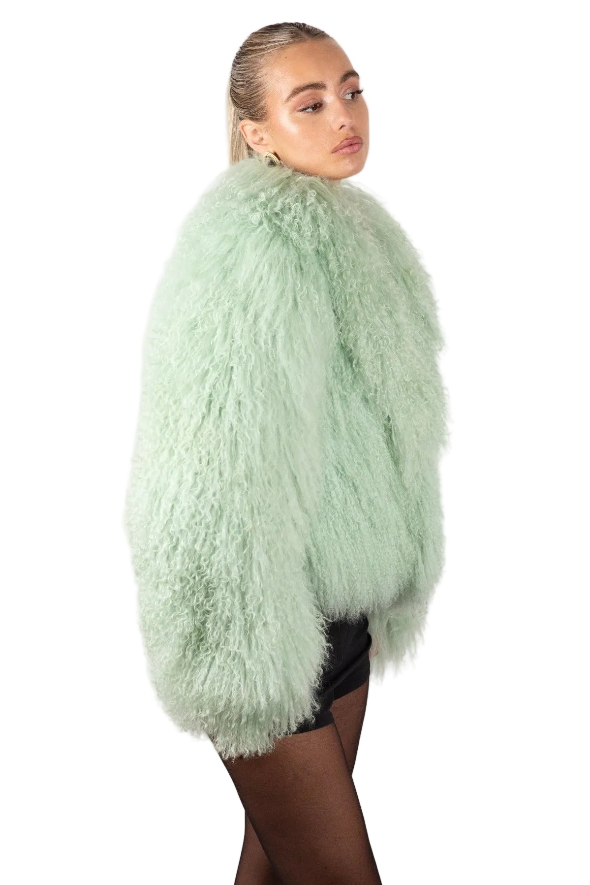 Person wearing a light green Mongolian fur  coat on a white background